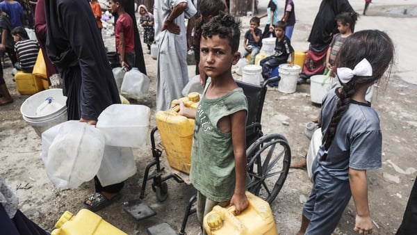 Palestinians fill their water canisters from an aid truck to provide water while Israel's brutal and destructive attacks on the blockaded Gaza Strip continue