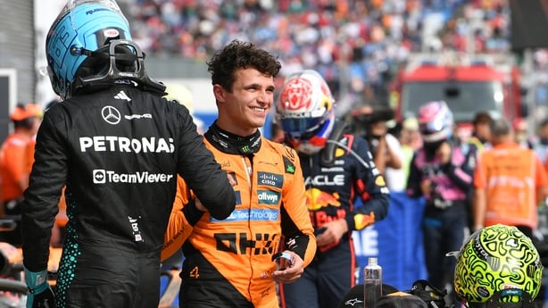 Third placed Mercedes' British driver George Russell (L) congratulates winner McLaren's British driver Lando Norris after the Formula One Hungarian Grand Prix at the Hungaroring circuit in Mogyorod near Budapest.