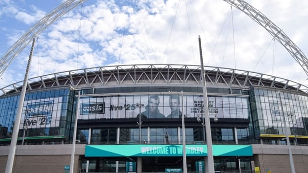 Screens at Wembley Stadium advertise the forthcoming gigs by Oasis