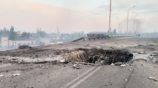 A bridge damaged with a large hole showing in Ukraine's Kherson region