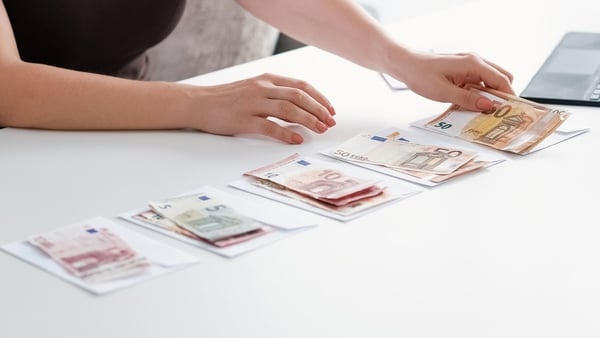 Euro notes are seen on top of envelopes