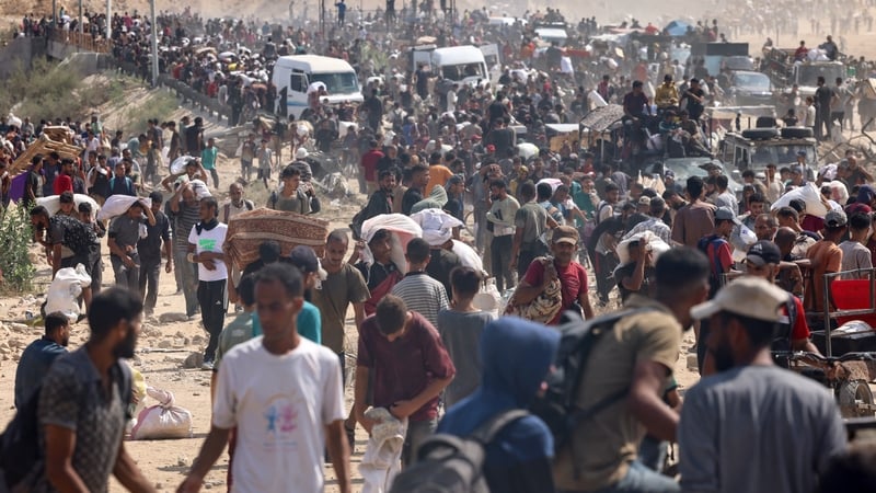 Displaced Palestinians gather to receive aid at a distribution centre run by the GHF at the Netzarim corridor in central Gaza