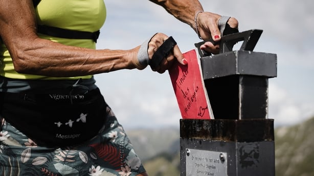 Cathy places the Mountain Tinder notebook at the top of Wandflue peak