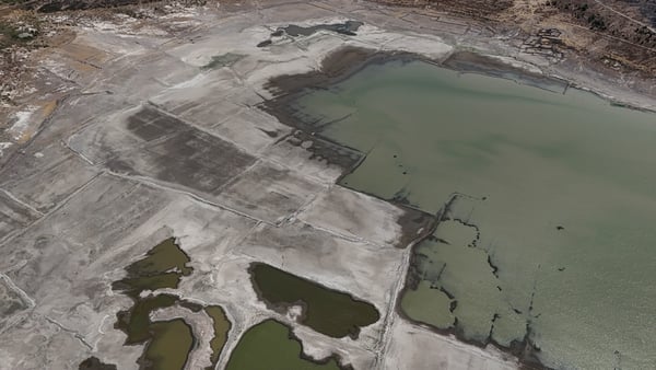 An aerial photograph shows the old Izmir-Cesme highway re-emerging at the Alacati Kutlu Aktas Dam as water levels drop in Izmir, Turkey