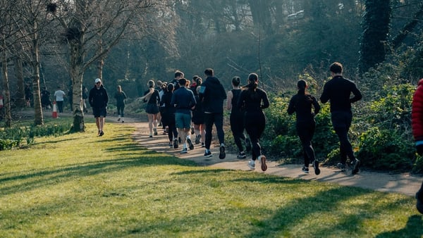 a group of joggers in a park
