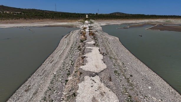 An aerial photograph shows the old Izmir-Cesme highway re-emerging at the Alacati Kutlu Aktas Dam as water levels drop in Izmir, Turkey
