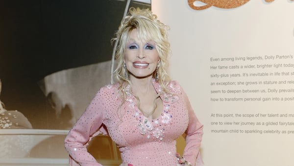 Dolly Parton smiles for the camera at the opening of Country Music Hall of Fame and Museum's new exhibit 'Dolly Parton: Journey of a Seeker
