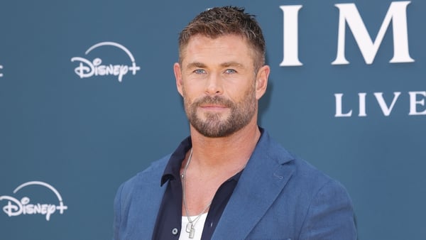 Chris Hemsworth poses for a photo on the red carpet