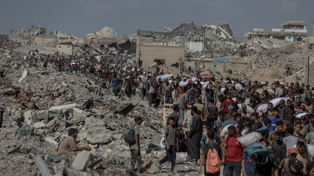 GAZA STRIP - AUGUST 5: Palestinians struggle with hunger amid Israeli attacks as the people rush to an aid distribution point near the Zikim Crossing in northwestern Gaza Strip on August 5, 2025. (Photo by Mahmoud Issa/Anadolu via Getty Images)