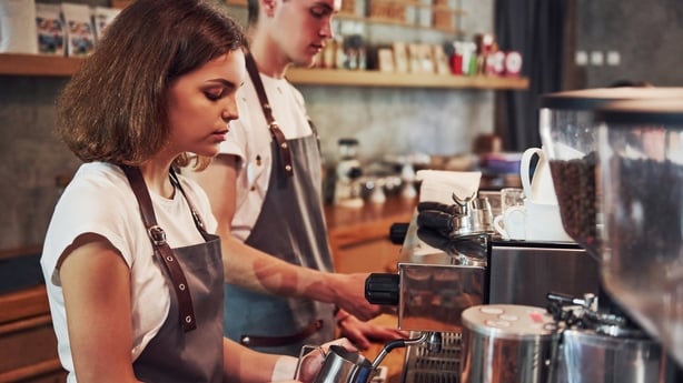 Young female cafe worker indoors. Conception of business and service.