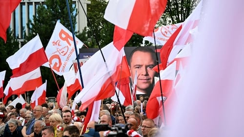 Supporters of Karol Nawrocki gather outside of Poland's parliament ahead of his inauguration