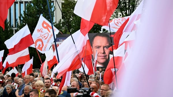 Supporters of Poland's new President hold flags and posters