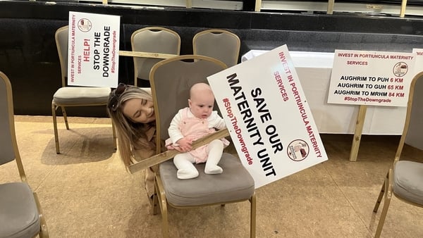 Image of a woman and her baby at public meeting in Ballinasloe