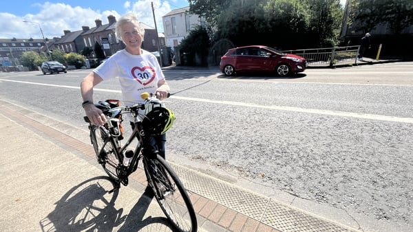 A photo of Mairead Forsythe with her bike on the Crumlin Road