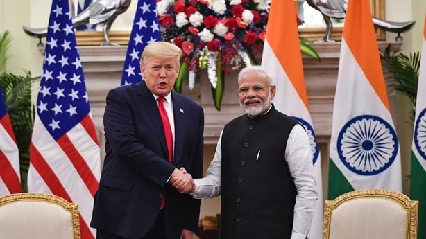 India's Prime Minister Narendra Modi shakes hands with US President Donald Trump