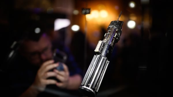 The screen-matched lightsaber prop, used by the character Darth Vader in the Star Wars films The Empire Strikes Back and Return of the Jedi, is displayed at a photocall ahead of an auction