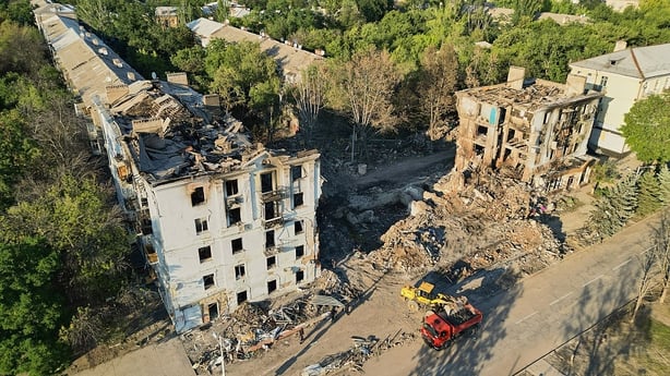 Rescuers from Ukraine's Emergency Services search through the rubble of a building bombed by Russian forces on July 31