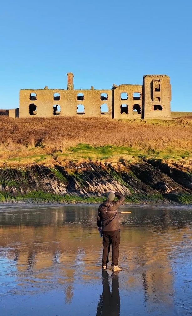 man taking a photo of a castle
