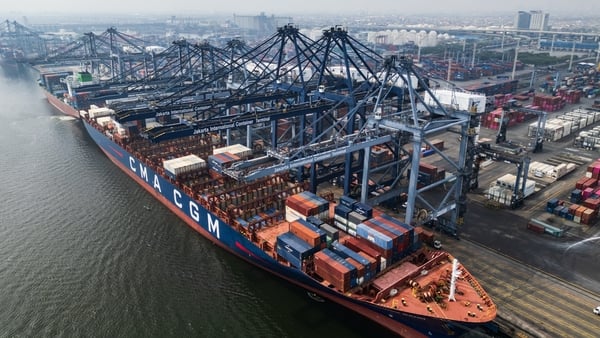 An aerial photo shows cargo containers stacked aboard a ship at the Jakarta International Container Terminal in Tanjung Priok Port, Jakarta