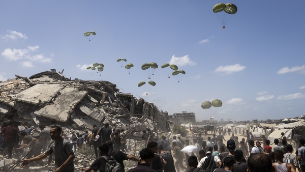 Planes drop aid packages by parachute amid Israeli attacks as the Palestinians flock to the area where the humanitarian aid packages land over western Gaza City