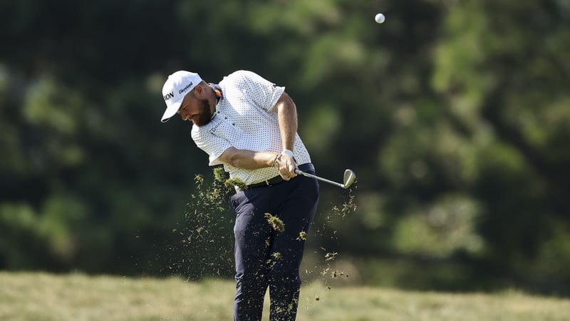 Shane Lowry plays his approach shot on the second hole