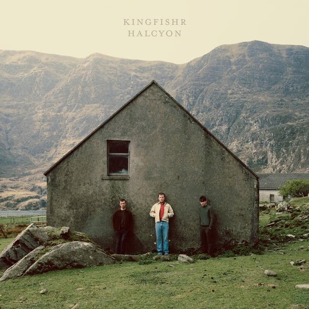 The cover of Kingfishr's debut album Halcyon, showing the members in front of an old house