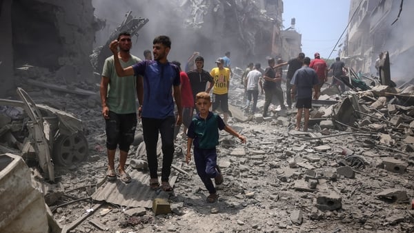 Palestinians check the devastation following an Israeli strike that hit Gaza City's southern al-Zeitoun neighbourhood