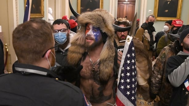 Supporters of US President Donald Trump, including member of the QAnon conspiracy group Jake A, aka Yellowstone Wolf (C), enter the US Capitol on 6 January 2021