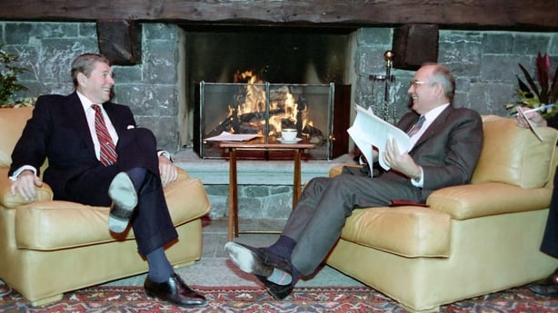 Ronald Reagan and Mikhail Gorbachev sit in front of a fire during a summit in Geneva in 1986