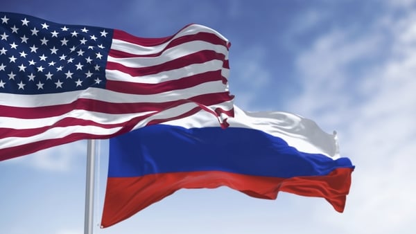 illustration of the National flags of USA and Russia waving in the wind on a clear day
