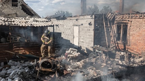 Ukrainian firefighters extinguish a fire in a house after Russian artillery shelling of the city of Kostiantynivka, Ukraine