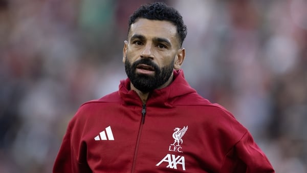 Close up of Mohamed Salah of Liverpool in a red jackied with Adidas and Liverpool logos with a blurred background