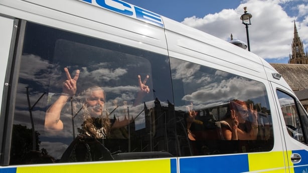 LONDON, WESTMINSTER, UNITED KINGDOM - 2025/08/09: Detained Palestine Action supporters give peace signs from inside a police vehicle during the demonstration. Defend Our Juries members and Palestinian Action supporters held a demonstration in Parliament Square calling for the de-prescription as a te