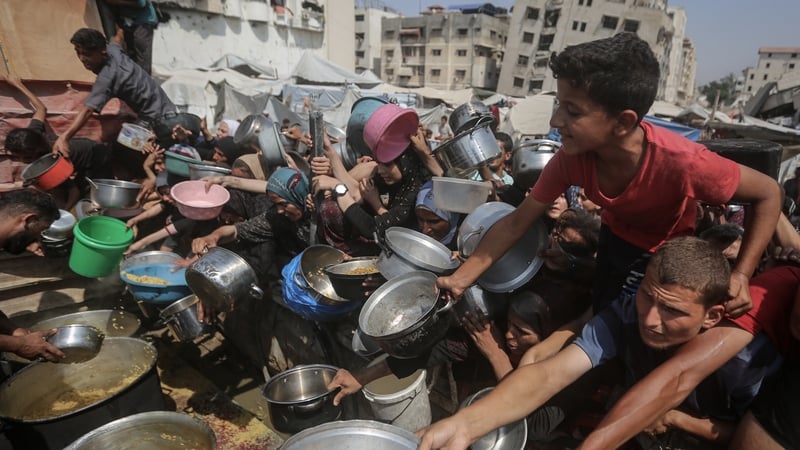 Palestinians wait to receive food distributed by a charity organization as Israel continue to block humanitarian aid from reaching the Gaza Strip. Photo: Khames Alrefi/Anadolu via Getty Images