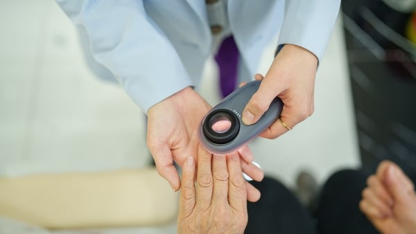 Female senior patient at the dermatology clinic for her nail care.