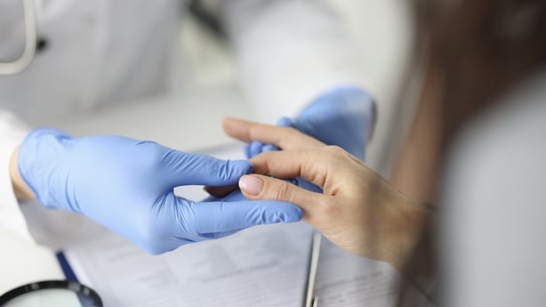 Doctor in gloves examines finger in a medical office concept