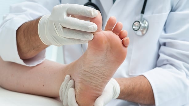 Doctor dermatologist examines the foot on the presence of athlete's foot