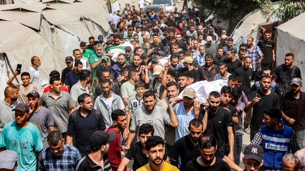 Mourners march with the bodies of the Al Jazeera journalists who were killed in an overnight Israeli strike in Gaza City