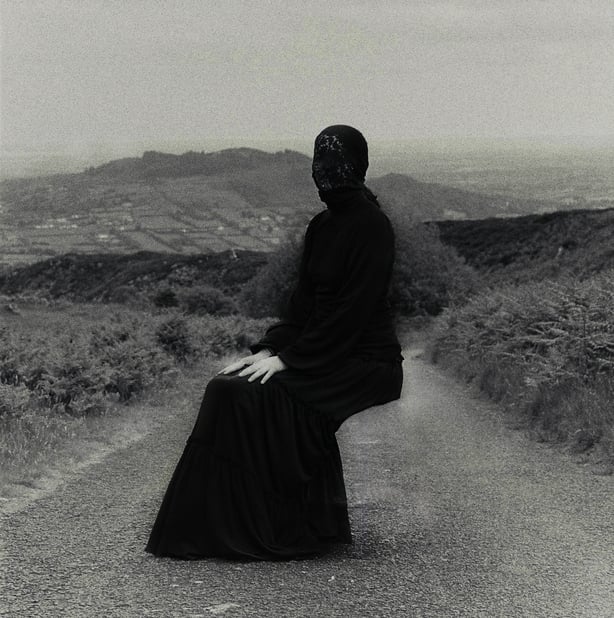 A woman sitting on a road