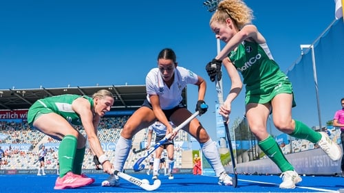 Ireland's Katie Larmour and Niamh Carey battle for possession with France's Catherine Clot