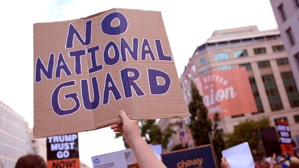 People participate in a rally against the Trump Administration's federal takeover of the District of Columbia