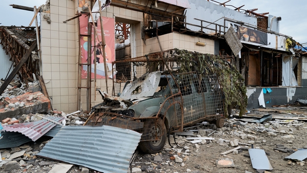 A damaged van is covered in the wreckage of an adjoining train station in Ukraine