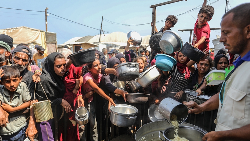 Palestinians wait for food in the Al-Mawasi area of Khan Younis in Gaza earlier this week
