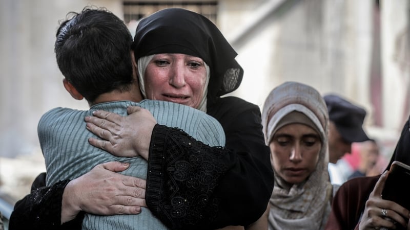 People seen mourning outside Al Shifa hospital in Gaza as bodies are removed from the facility