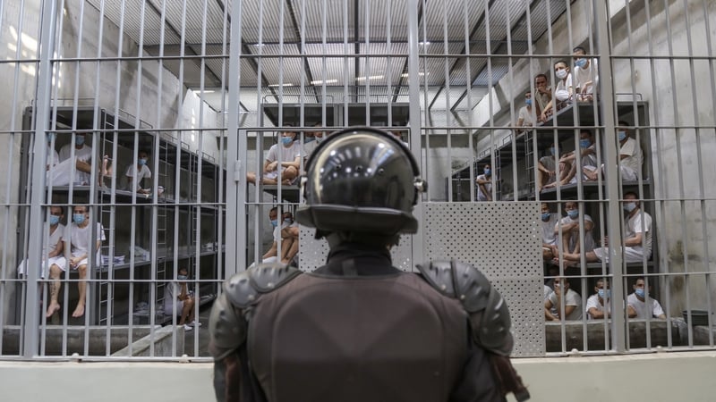 A prison officer stands in front of a cell the maximum security penitentiary CECOT in Tecoluca, San Vicente, El Salvador