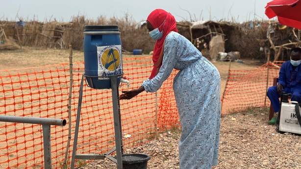 A woman washes her hands at the entrance of a cholera isolation centre at the refugee camps of western Sudan, in Tawila city in Darfur