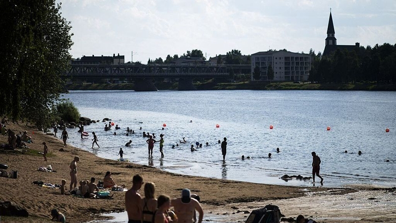People bathing at the Ounaskoski Beach at the Arctic Circle in Rovaniemi, Finnish Lapland last month