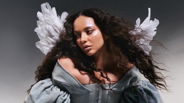 Singer Jade wearing angel wings in a photoshoot
