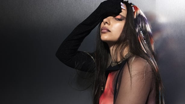 Singer Jade holding her hand to her face