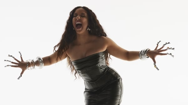 Singer Jade in a photoshoot holding out her arms